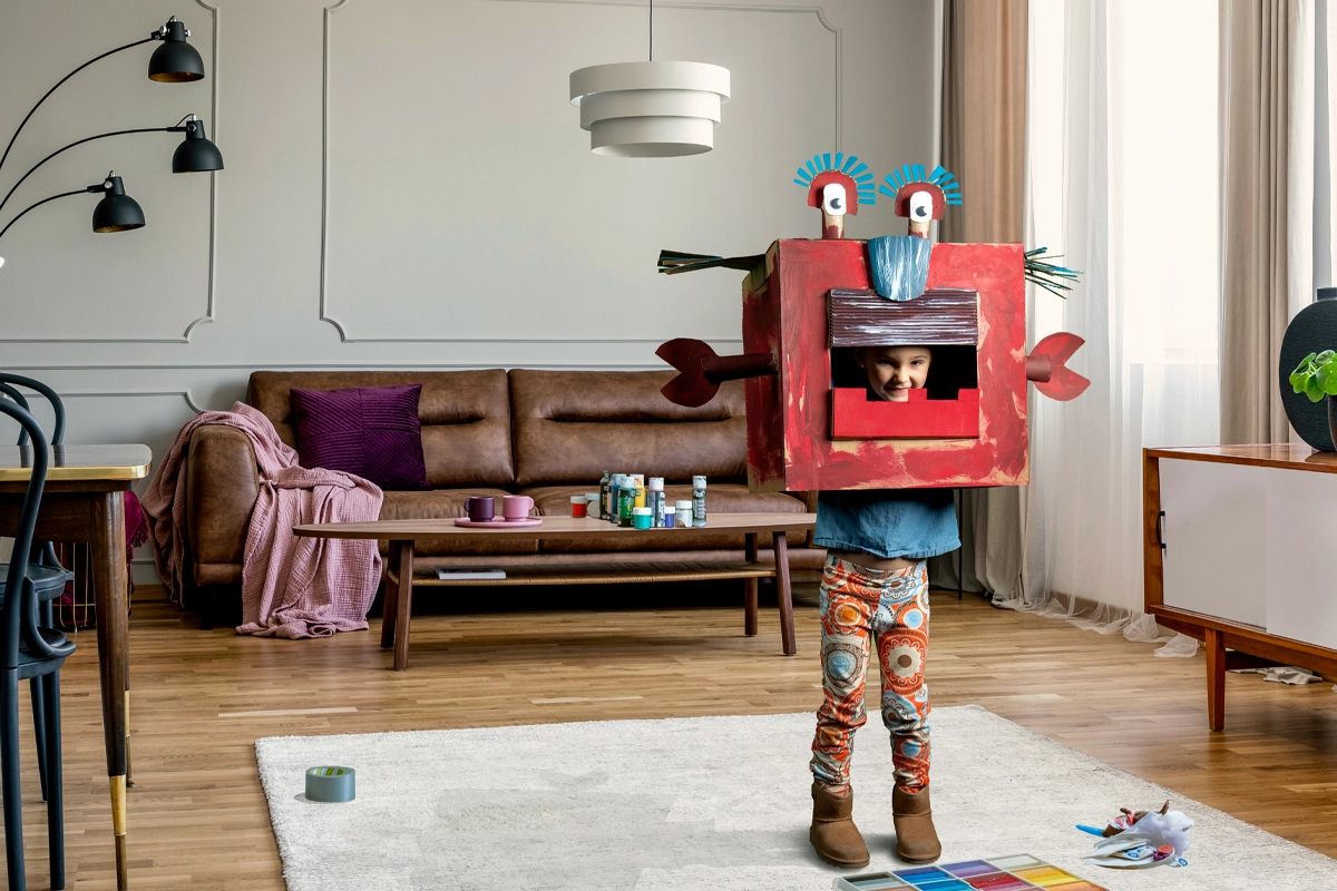 Girl wearing corrugate monster costume in living room